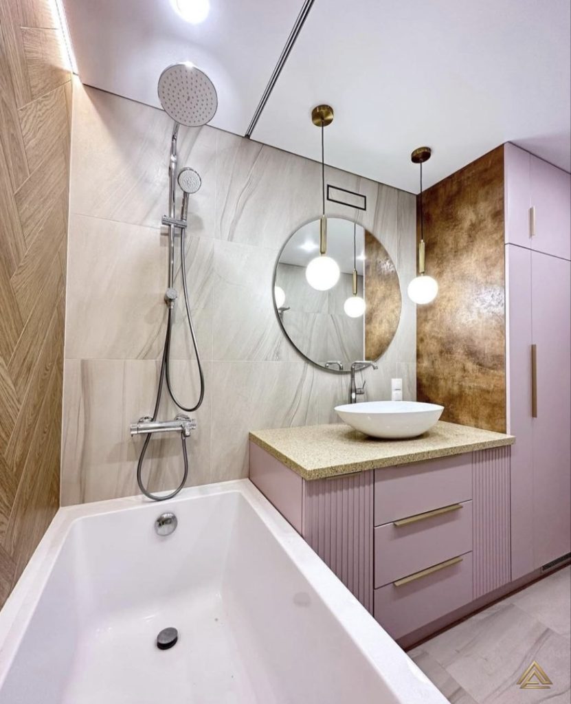 Projet de rénovation de salle de bain (mobilier rose poudré, vasque bol et miroir rond), réalisé par PRO BAT-IM, à Val-de-Marne.